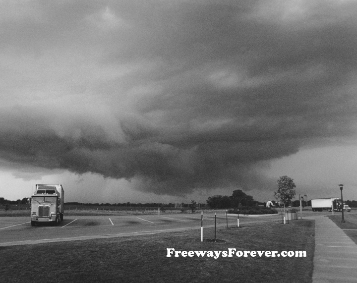 Kenworth cab over COE truck with Aerodyne sleeper at a rest stop in southern Wisconsin with severe storm approaching