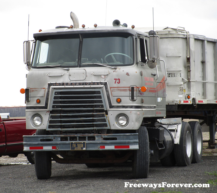 Thomas Family Farms International Transtar tractor trailer cabover parked in Delaware with a Parker trailer