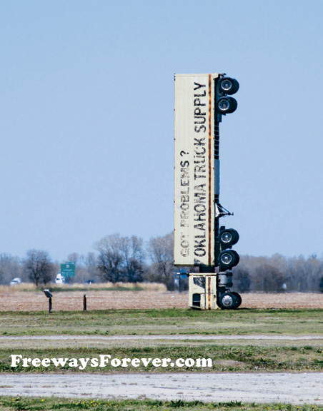 Cabover tractor-trailer upended vertical as a sign for Wilkins Oklahoma Truck Supply sign near Interstate 35 at Tonkawa
